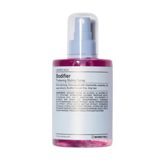 J Beverly Hills Blue Bodifier bottle on display boosts volume for fine hair.