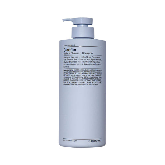 J Beverly Hills Blue Clarifier Shampoo bottle pouring for deep cleanse and hydration.