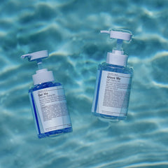 J Beverly Hills Blue Gel Me hands applying on damp hair for sculpted style.