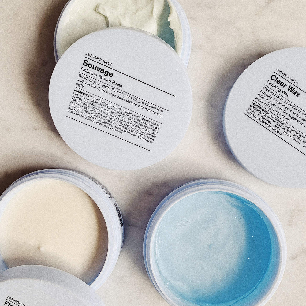 J Beverly Hills Blue Souvage Paste in hands for shaping texture.