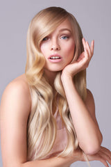 J Beverly Hills Platinum Volume Conditioner hair swirl displays silky texture and moisture boost.