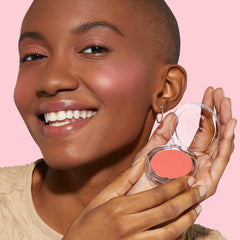 JOAH hand holding compact for scale showing travel-friendly size