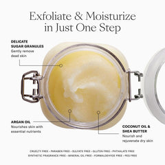 Applying Josie Maran Sugar Body Scrub in circular motions on the arm