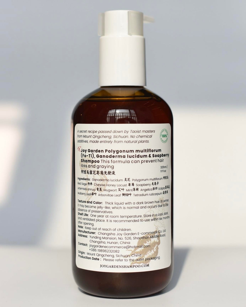 Joy Garden He Shou Wu shampoo bottle with herbal formula for daily cleansing.