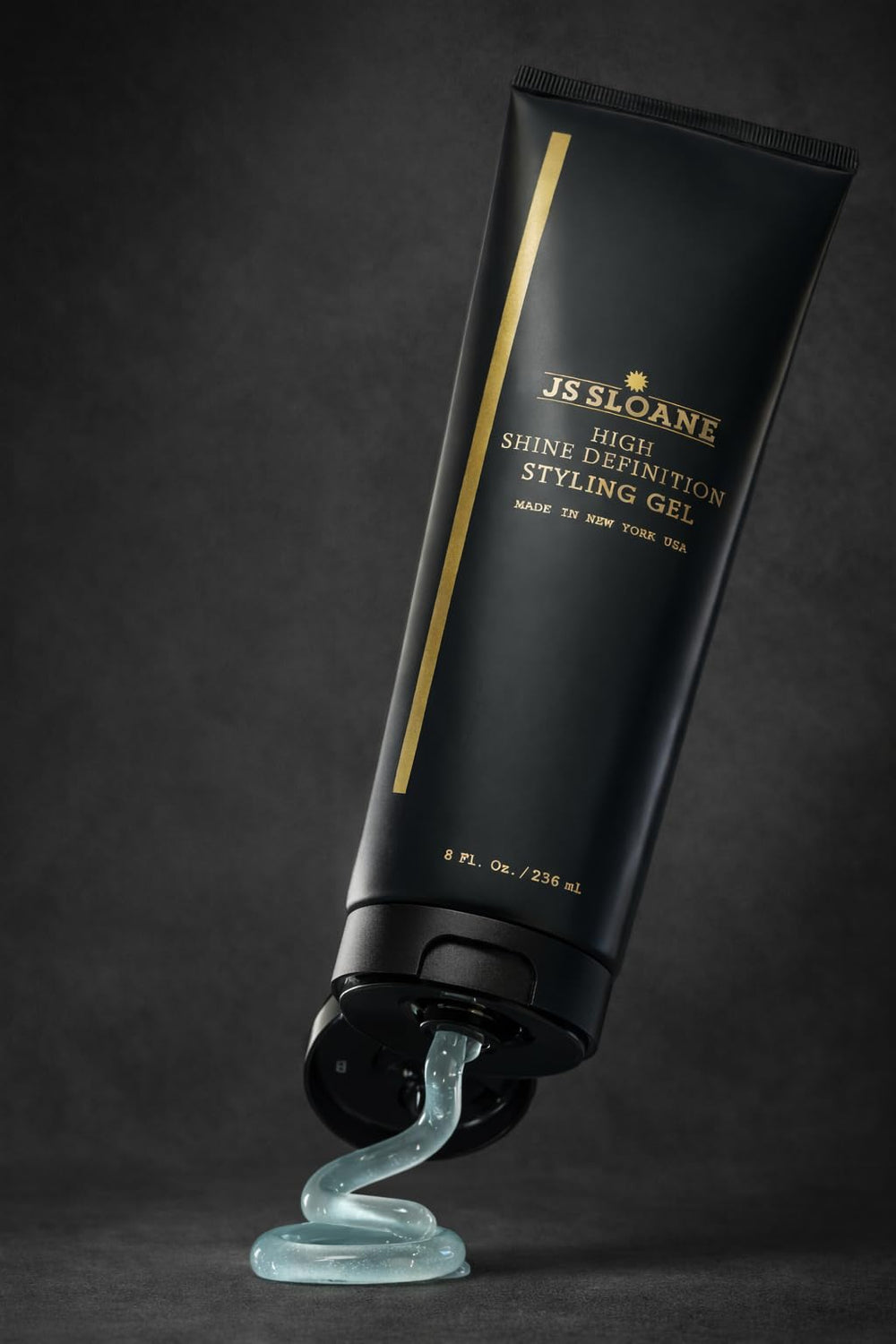 JS Sloane styling gel application hand for smooth, flop-free slick-back looks.