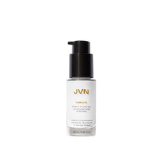 JVN Complete Blowout Styling Milk bottle pour showing easy application and heat protection preparation.