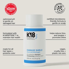 K18 Damage Shield Shampoo label close-up indicating premium care for smooth hair.