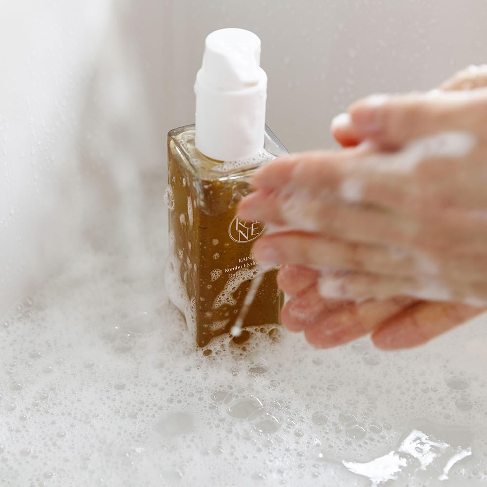 KAINE cleanser applied on damp skin for a gentle, hydrating cleanse