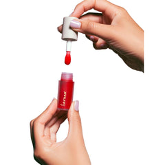 Karuna Skin Tinted Lip Oil applicator in use delivering even color.