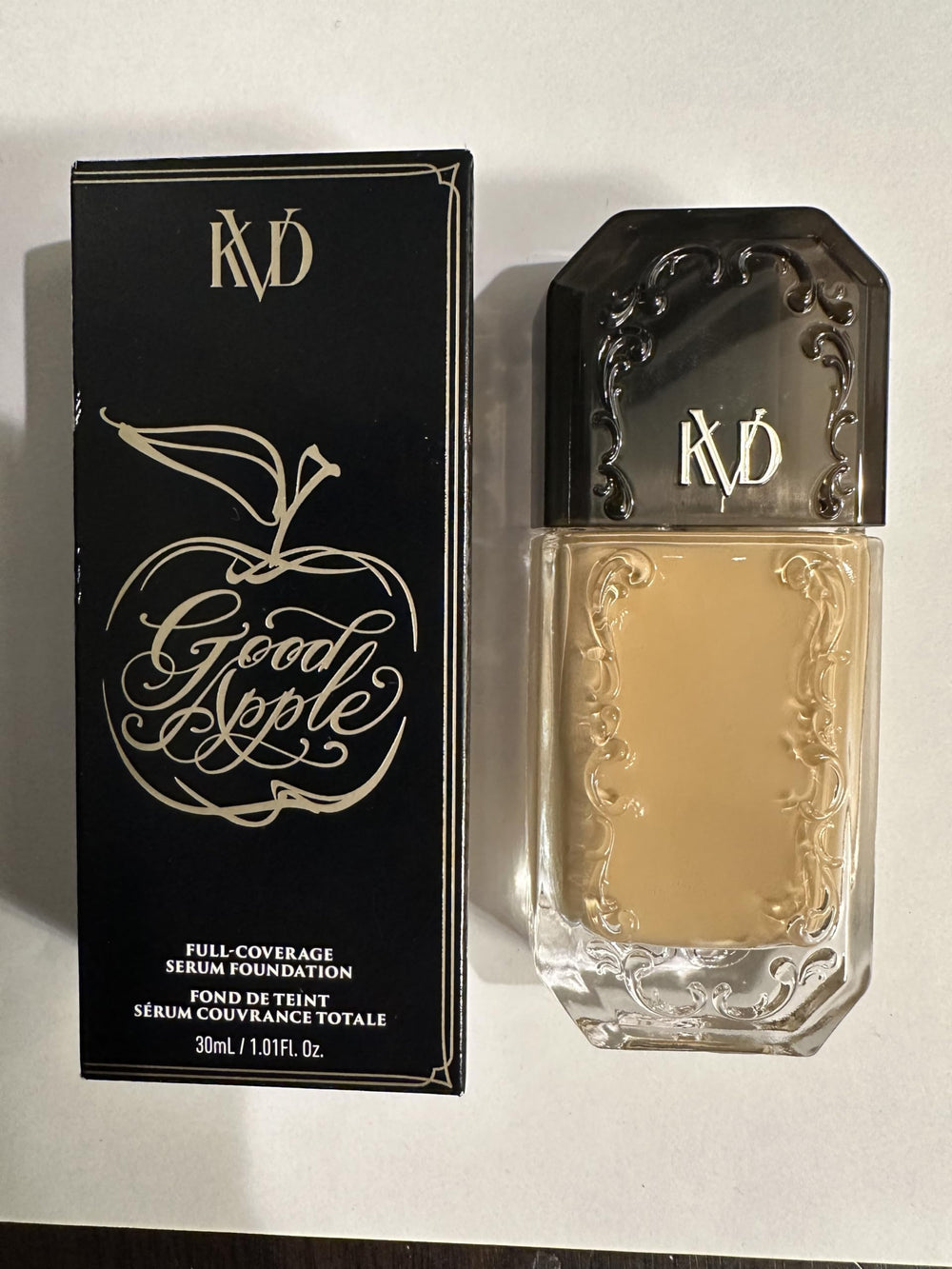 Kat Von D Good Apple serum foundation Tan 057 bottle shows radiant finish.