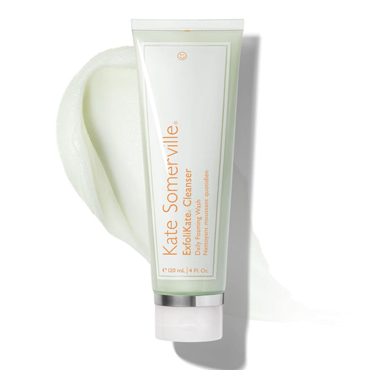Kate Somerville Exfolikate Cleanser bottle on sink for daily exfoliation.