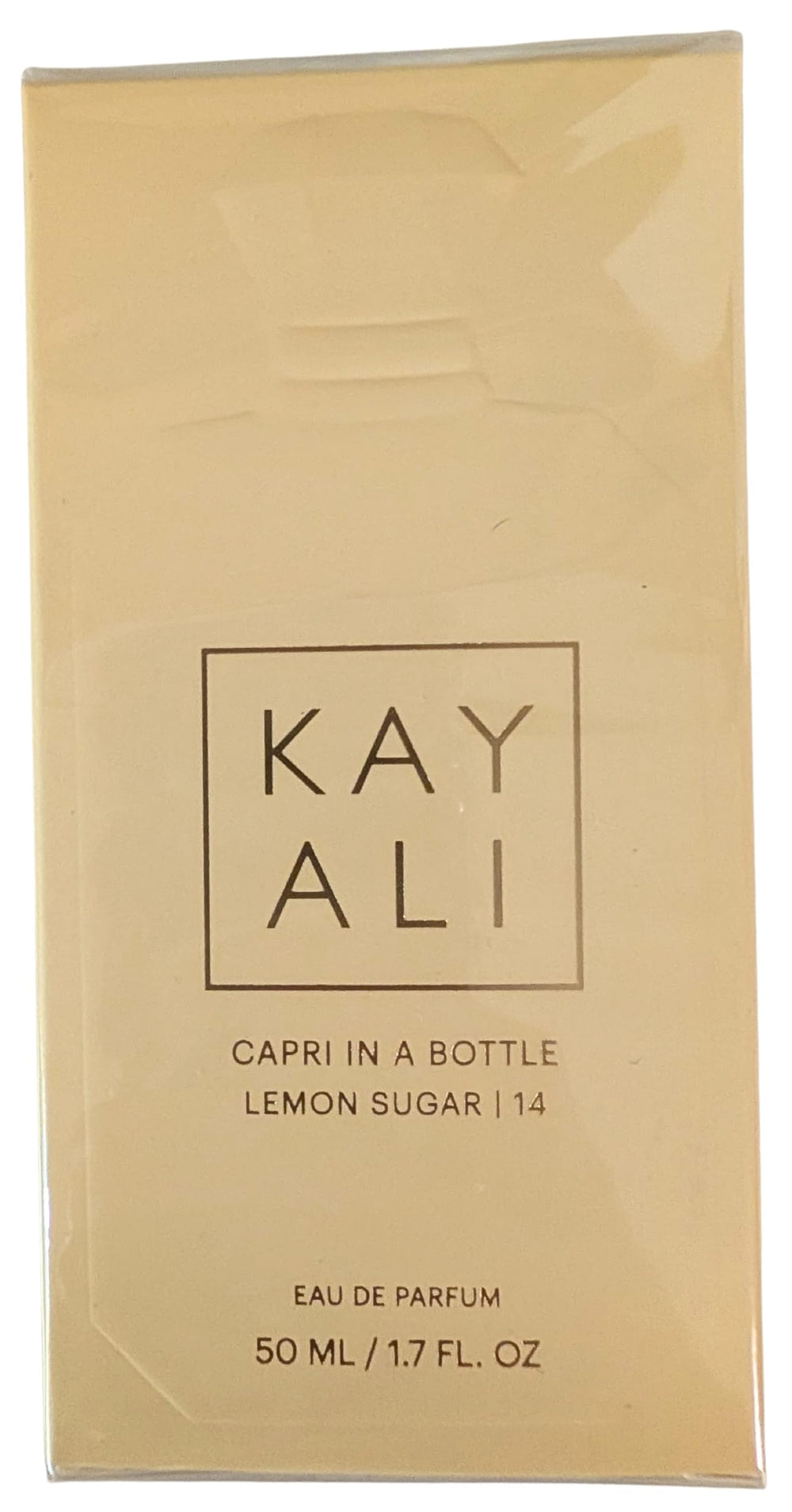 Kayali Capri in a Bottle lifestyle shot suggests everyday elegance and sunny mood.