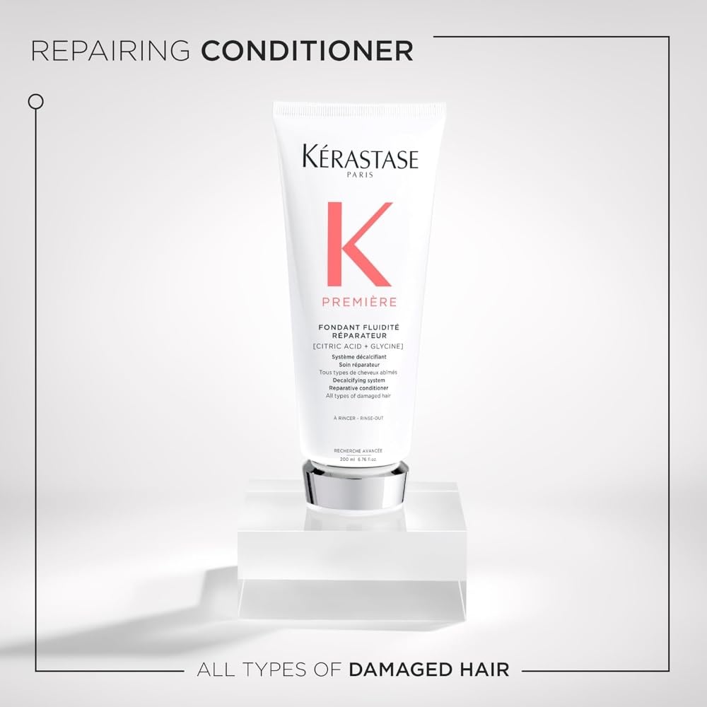 Applying Kerastase Premiere to damp hair for dual-action repair.