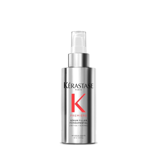 Kerastase Premiere serum bottle pouring for smooth hair and frizz control.