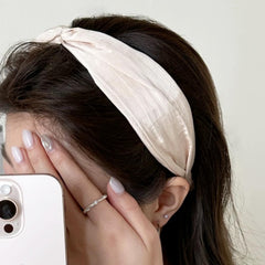 KOVOLITU cross knot satin headband stays in place during workouts