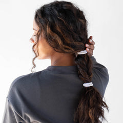 L. Erickson hair ties demonstrating strong hold on a thick ponytail