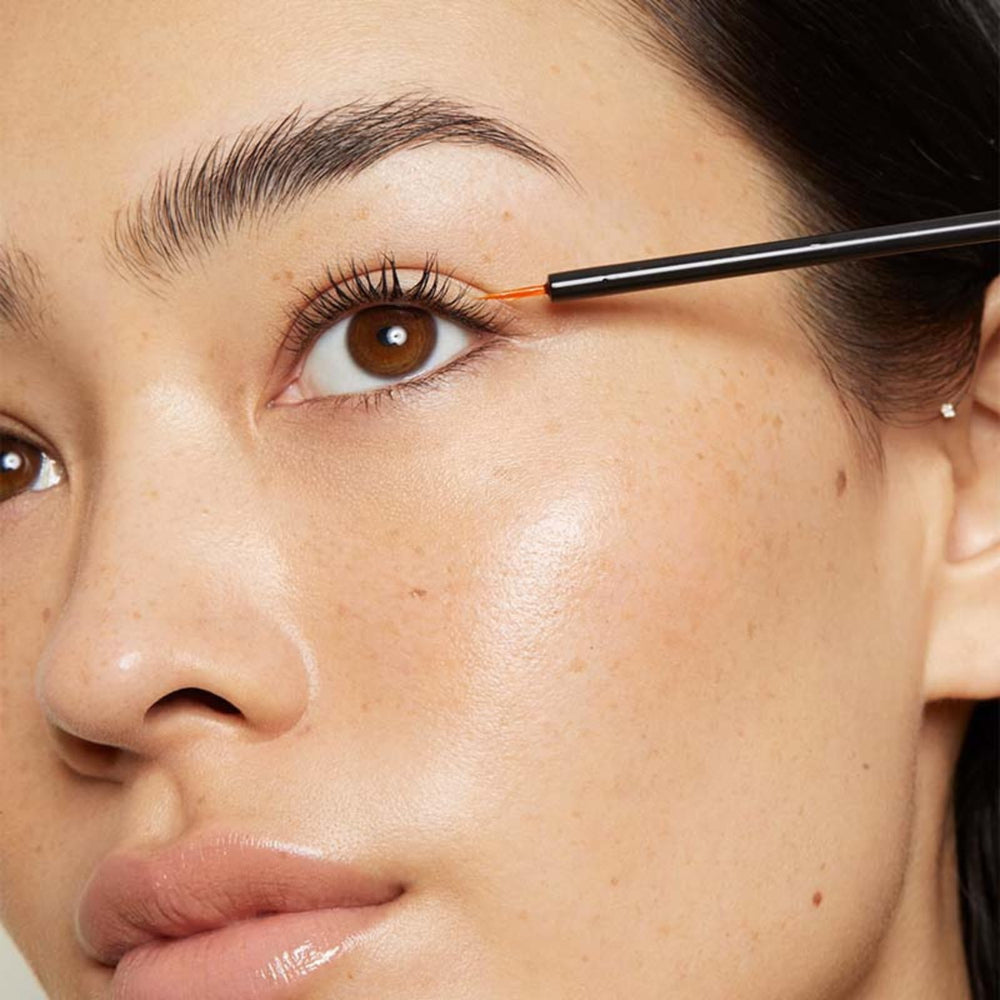 LashFood serum close-up applying along lash line for targeted care.