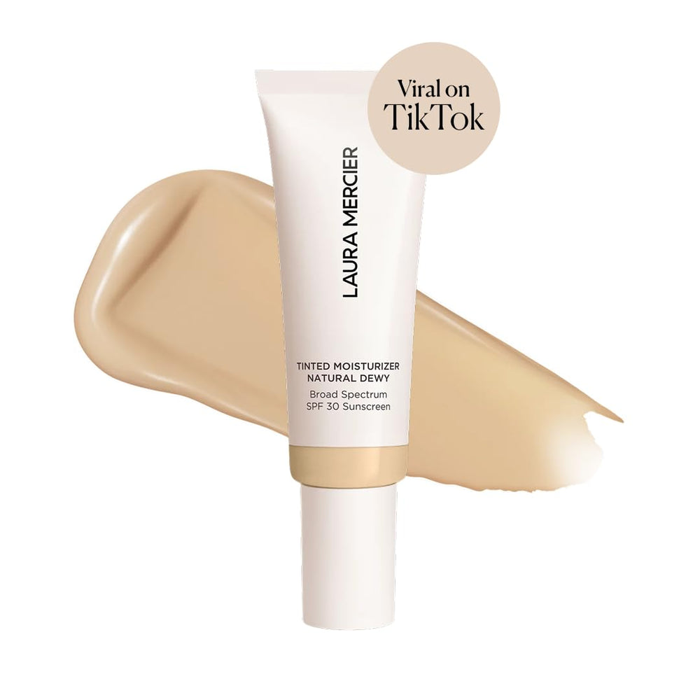 Laura Mercier Tinted Moisturizer swatch on skin shows sheer-to-light coverage.