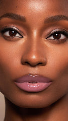 Lawless gloss swatch on skin showing creamy texture and subtle color payoff