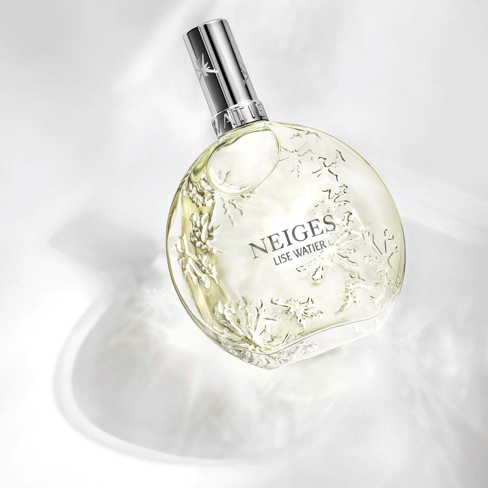 Lise Watier Neiges bottle cap close-up, hinting at premium fragrance experience