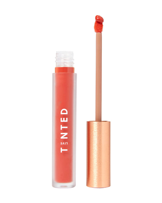Live Tinted Huelip Lip Crème bullet close-up, orangey red color for all-day wear