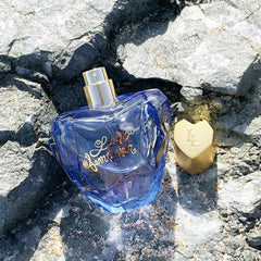 Lolita Lempicka Mon Premier bottle close-up jewel-cut violet cap, signaling premium scent.