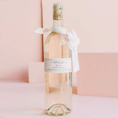 Lollia Relax Bubble Bath featuring white flower corsage on premium display