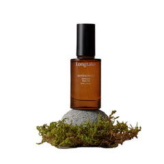 LONGTAKE Sandalwood Hair Oil bottle shows glossy finish.