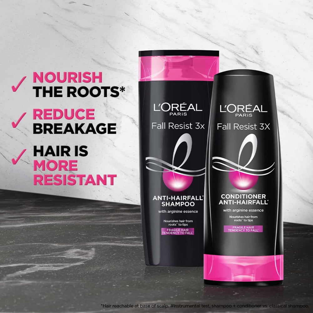 L'Oreal Paris Fall Repair 3X bottle in hand demonstrates portable cleansing option