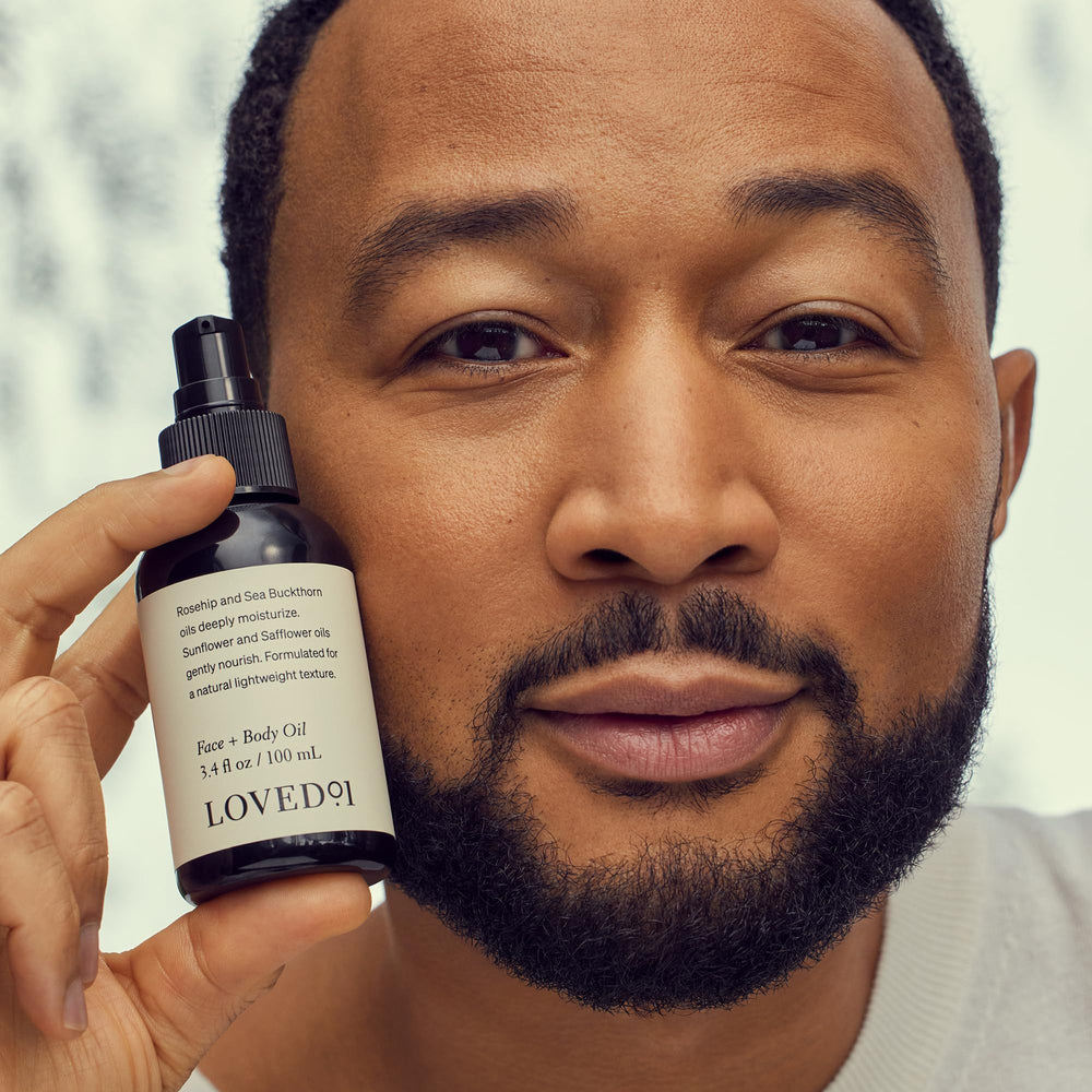 Hand applying Loved01 Face & Body Oil head-to-toe for daily hydration
