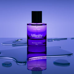LOVERY Affinity at Midnight wearer applying perfume on neck, creating a warm inviting aura.