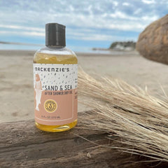 Close-up of Sand & Sea ingredients highlighting plant oils and vitamin E.