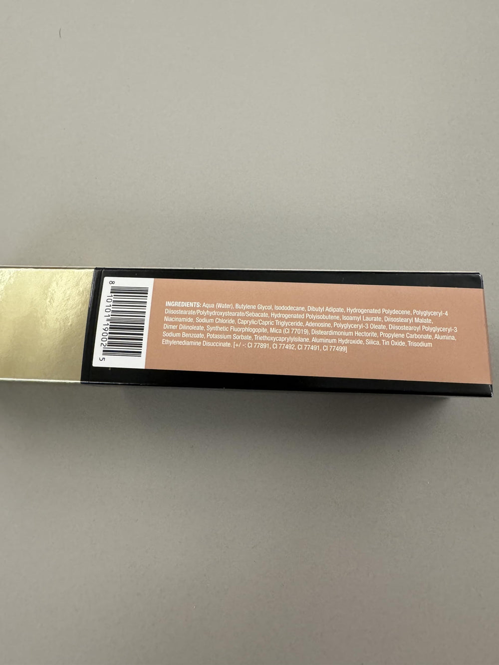 MAKE Beauty Diffusion Dew Skin Tint application on the cheek with even finish.
