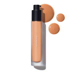 MAKE Beauty Diffusion Dew Skin Tint bottle with pour showing natural coverage.