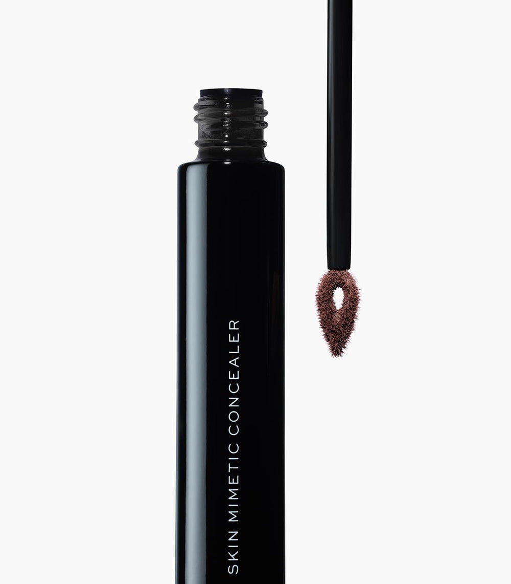 MAKE Beauty Skin Mimetic Concealer deep cool shade bottle highlights rich tones.