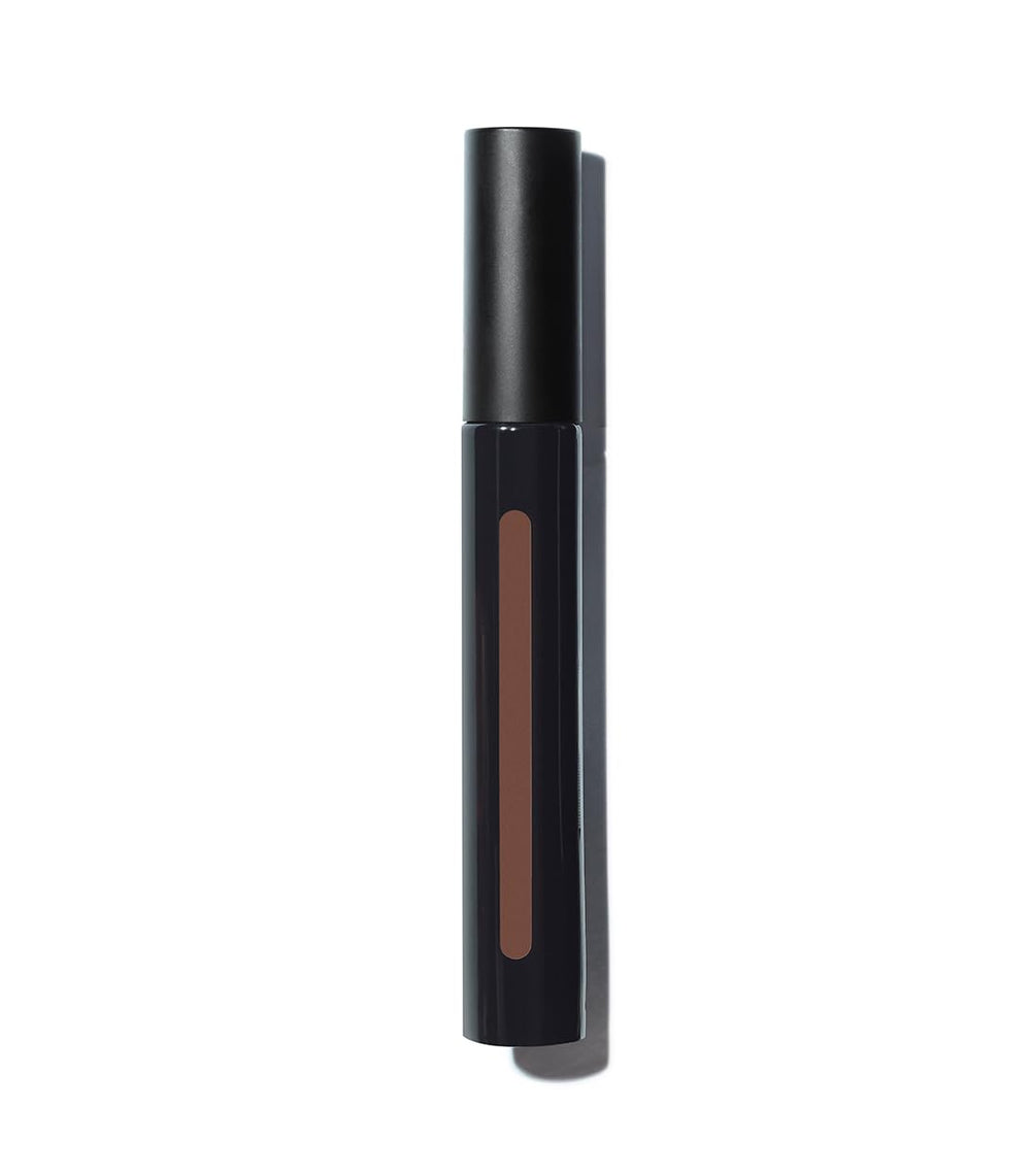 Texture close-up reveals creamy, lightweight concealer blending smoothly.