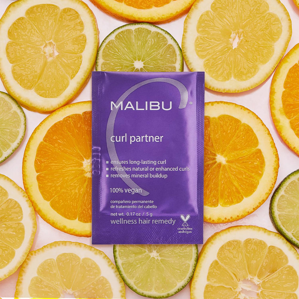 Malibu C Curl Partner Wellness Remedy crystals dissolving on damp hair for detox