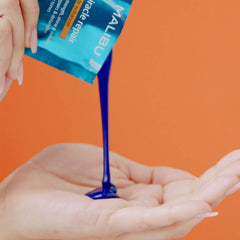 Malibu C Miracle Repair Blonde Enhancer packet in product shot, counters brassiness with purple toning.
