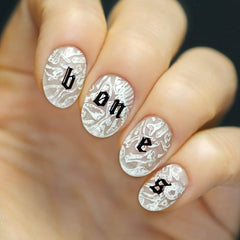 Maniology stamping over a dark base for crisp lines