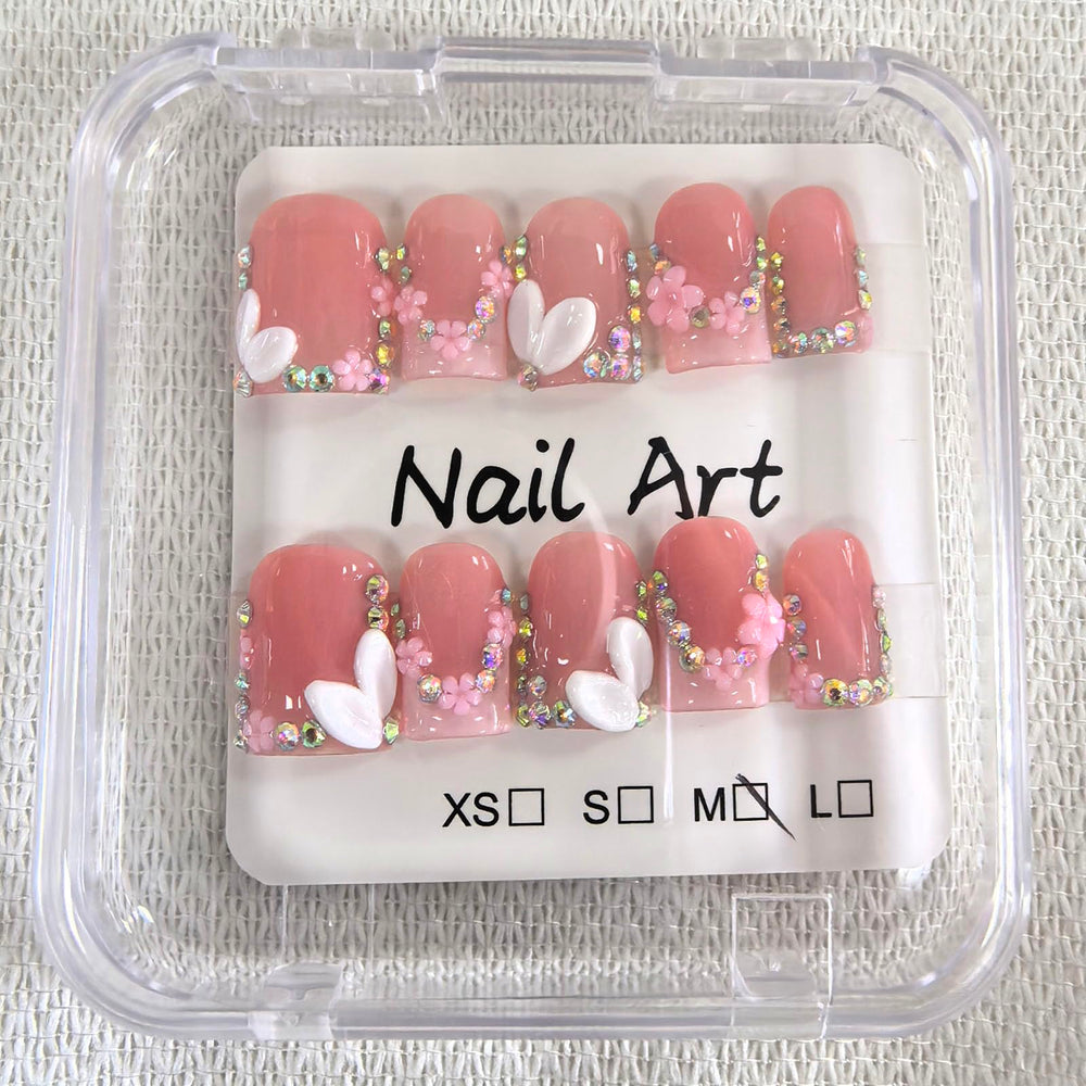 Meemooron 3D flower design with rhinestones on nails.