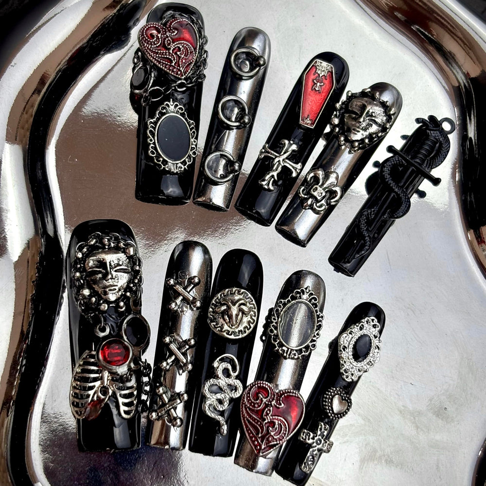MellowBells black lace baroque nails closeup with rivet accents for bold styling.