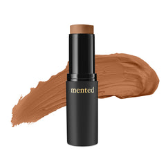 Mented stick foundation swatch on deep-tan skin for even coverage.