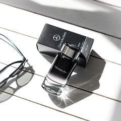 Mercedes-Benz Intense bottle on a dark surface reflects smoky luxury and refinement.