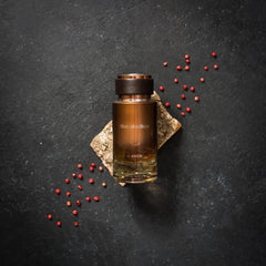 Close-up of Le Parfum bottle on a dresser shows masculine design.