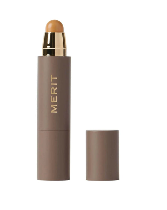 MERIT Minimalist Foundation and Concealer Stick Camel swatch for natural coverage.