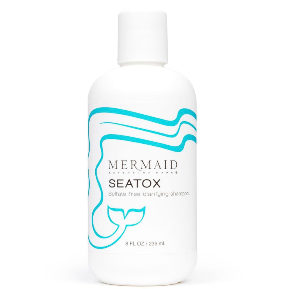 Mermaid Extension Care Seatox clarifying shampoo bottle pouring for deep cleansing on extensions.