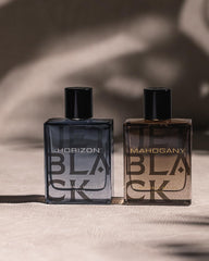 Michael Malul Jet Black Horizon amber liquid seen in splash bottle.