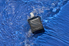 Close-up of Ocean Noir travel spray showing amberwood and musk hints.