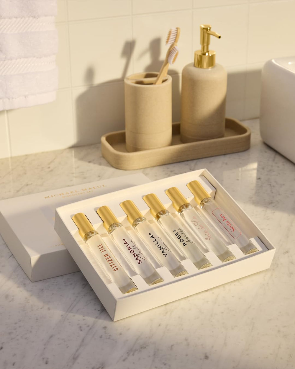 Michael Malul travel-friendly 10ml bottles shown in a sleek case.