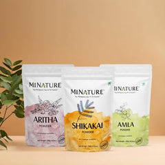Minature hair care routine setup with bowls and powders.